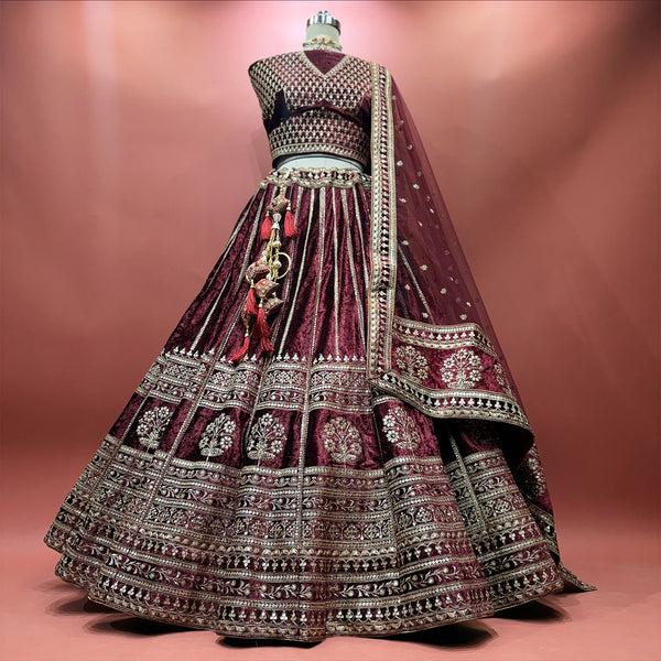 Maroon velvet lehenga with zari and sequin detailing, flared skirt on mannequin