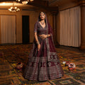 Maroon velvet lehenga with embroidered waistband and tiered skirt with silver borders