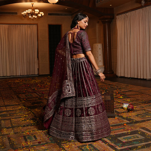 Maroon velvet lehenga from the back with embroidered yoke and trailing dupatta