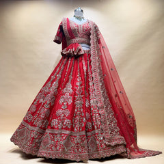 Red lehenga with silver-toned embroidered motifs and decorative hem, plus matching sheer dupatta