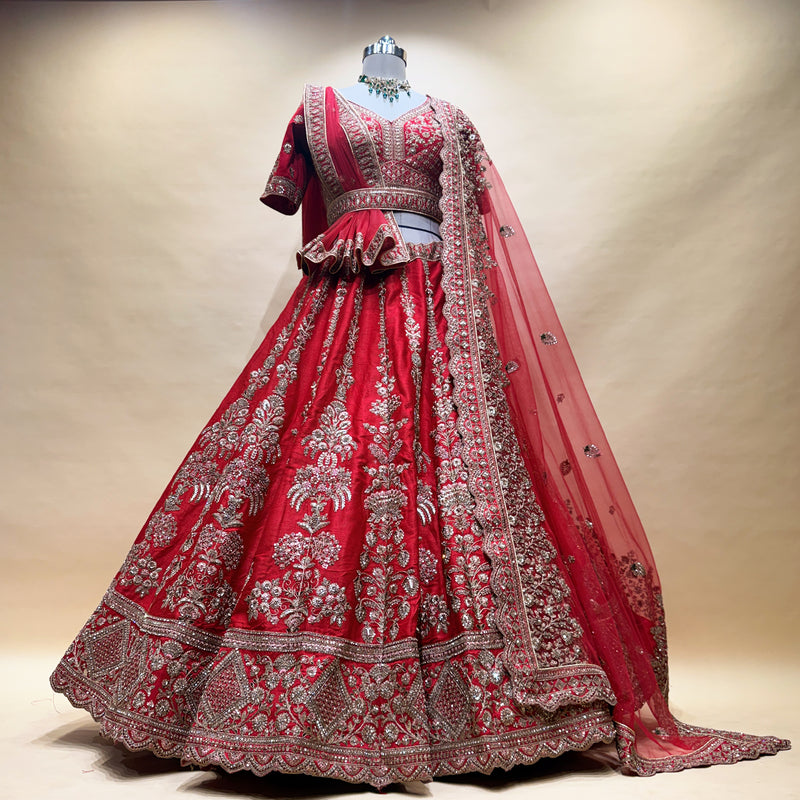 Red lehenga with silver-toned embroidered motifs and decorative hem, plus matching sheer dupatta