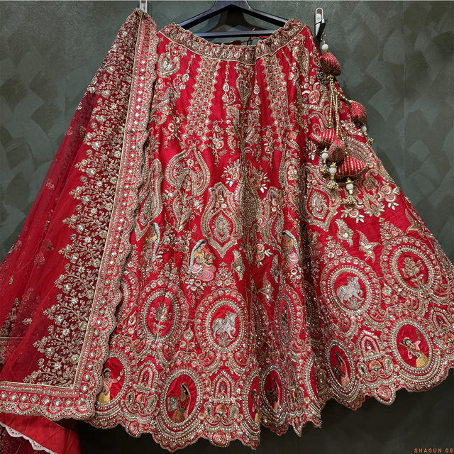 Red and silver embroidered lehenga skirt with detailed border and hanging tassel trim