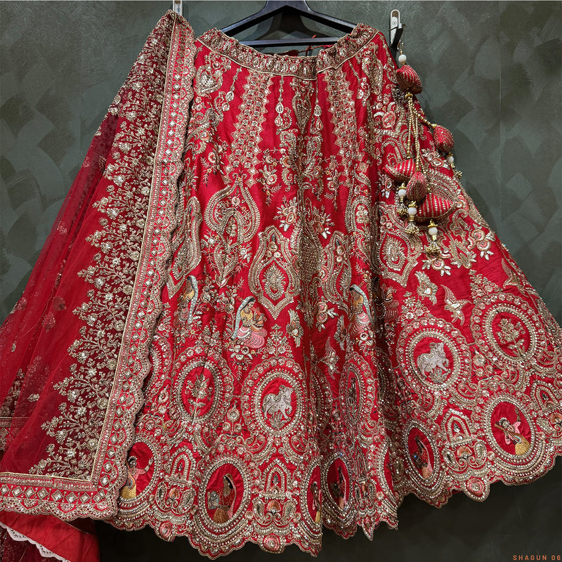 Red bridal lehenga skirt with detailed silver-gold paisley embroidery border and tassel trim