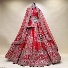 Red bridal lehenga with detailed gold embroidery and sheer dupatta