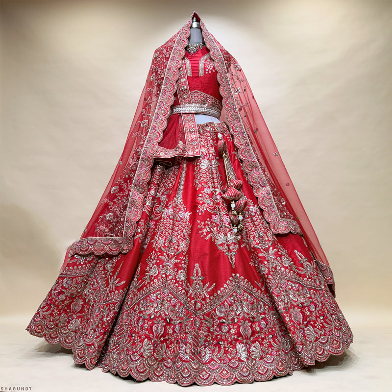 Red bridal lehenga with detailed gold embroidery and sheer dupatta