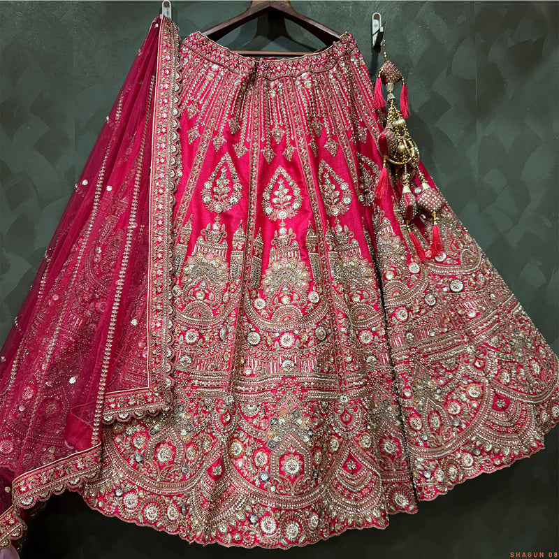 Rani pink bridal lehenga with heavy silver-gold embroidery, bead and cutdana motifs