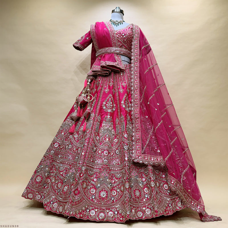 Pink bridal lehenga on mannequin with ornate silver sequin beadwork and sheer dupatta