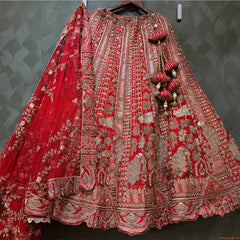 Red embroidered bridal lehenga skirt with silver borders and hanging bead tassels
