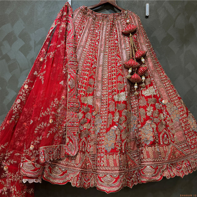 Red embroidered bridal lehenga skirt with silver borders and hanging bead tassels