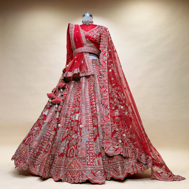 Red bridal lehenga with detailed silver embroidery, full skirt and draped dupatta