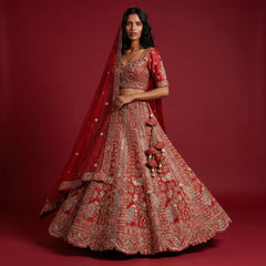 Red embroidered bridal lehenga with gold motifs and matching sheer dupatta