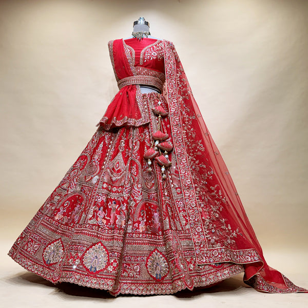 Red bridal lehenga with ornate silver panel embroidery and layered skirt border