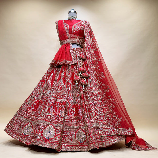 Red bridal lehenga with ornate silver panel embroidery and layered skirt border