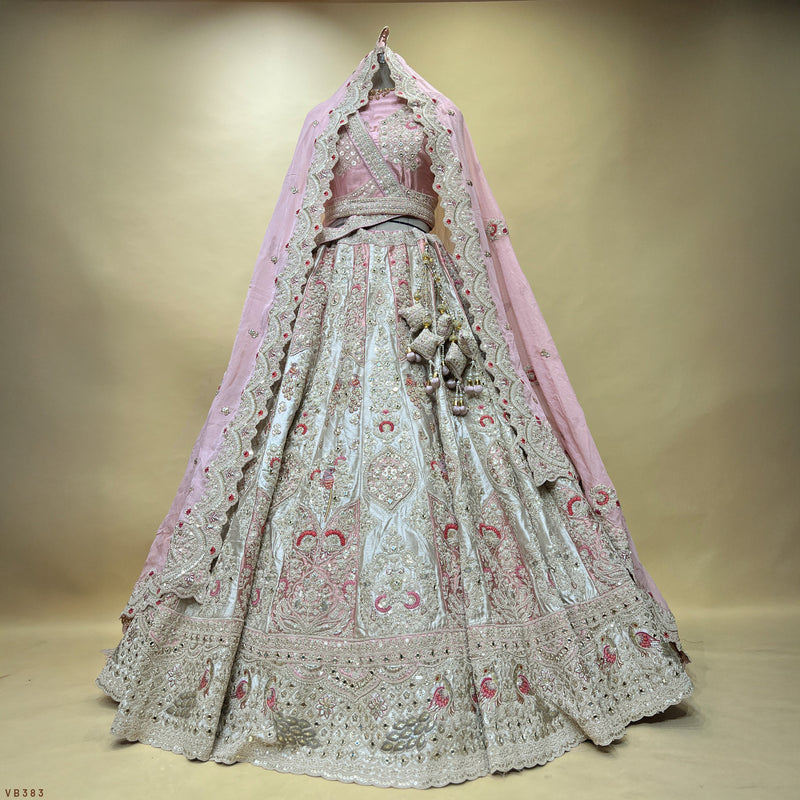 Embroidered pastel lehenga with silver detailing, light blue skirt, pink and maroon motifs