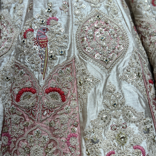 Embroidered light fabric with silver patterns, pink flowers, maroon details, bird motif