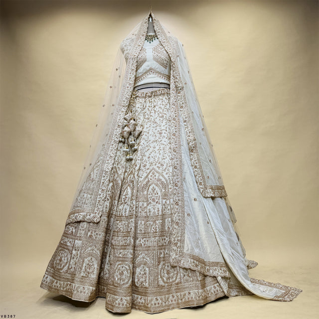 Ivory lehenga skirt with ornate gold embroidery and matching dupatta
