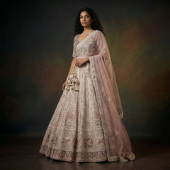 Pastel bridal lehenga with detailed doriwork embroidery and sheer dupatta drape