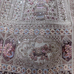 Close-up of pastel bridal lehenga embroidery with multicolor doriwork motifs