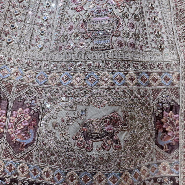 Close-up of pastel bridal lehenga embroidery with multicolor doriwork motifs