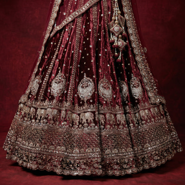 Maroon embroidered lehenga skirt with ornate borders and dense silver-tone handwork