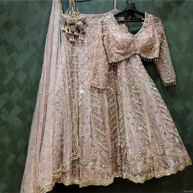 Soft pink embroidered lehenga skirt with bead embellishment and matching blouse