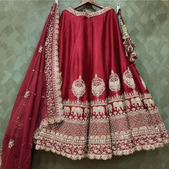 Maroon bridal lehenga front with ornate silver border and elephant motif panels