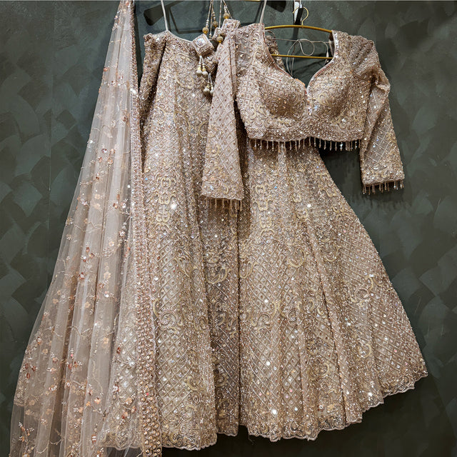 Champagne gold embroidered lehenga set with matching blouse and sheer dupatta
