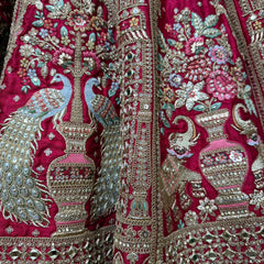 Pink lehenga closeup with silver beadwork, mirror embellishments, floral and peacock motifs