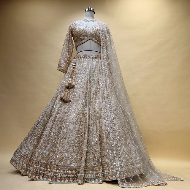 Ivory bead-embroidered bridal lehenga set with flared skirt and net dupatta
