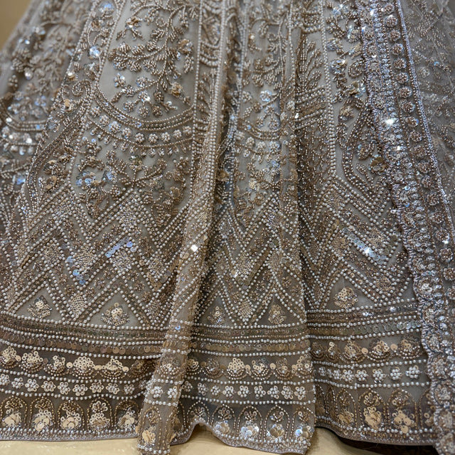 Bead and sequin handwork on lehenga skirt with ornate border trim