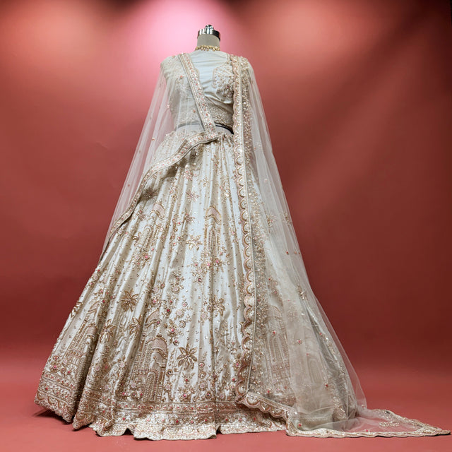 Ivory bridal lehenga with allover embroidery and sheer dupatta drape