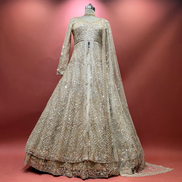 Champagne sequined net bridal lehenga gown with long sleeves and scalloped hem