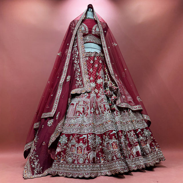 Maroon bridal lehenga with detailed beadwork and embroidered border, flowing dupatta