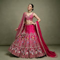 Rani pink bridal lehenga with embroidered floral border and two dupattas