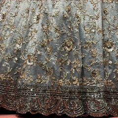 Close-up of grey tissue silk lehenga: bronze and smoke floral vines above a dark beaded scalloped border