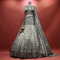 Silver-grey tissue silk lehenga with black cutdana chevron yoke, bronze vine embroidery and black scalloped hem