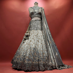 Silver-grey tissue silk lehenga with black cutdana chevron yoke, bronze vine embroidery and black scalloped hem