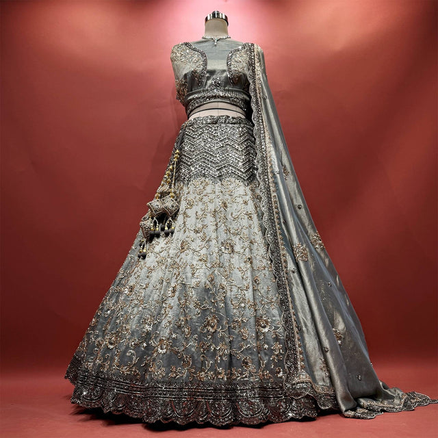 Silver-grey tissue silk lehenga with black cutdana chevron yoke, bronze vine embroidery and black scalloped hem