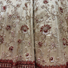 Close-up of ivory tissue silk lehenga: scrolling vines with red-filled flowers in cutdana and beadwork