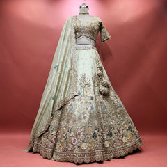 Pista green tissue silk lehenga with swan and flowering tree embroidery, scalloped hem, beaded blouse and tassels