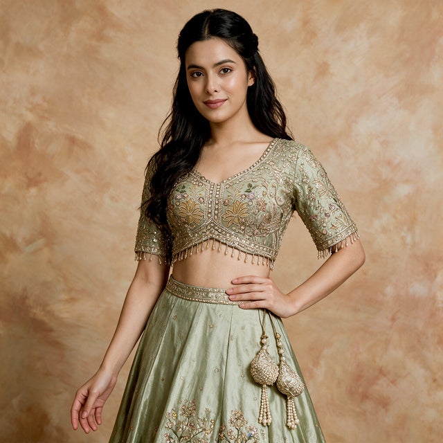 Pista green lehenga with gold embroidered short-sleeve blouse and tiered skirt