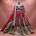 Maroon raw silk bridal lehenga with slim zari kalka panels, deep embroidered hem band, beaded blouse and double dupatta