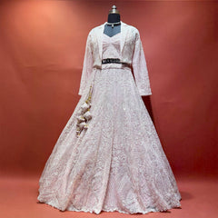 Baby pink net handwork lehenga set with jacket on mannequin