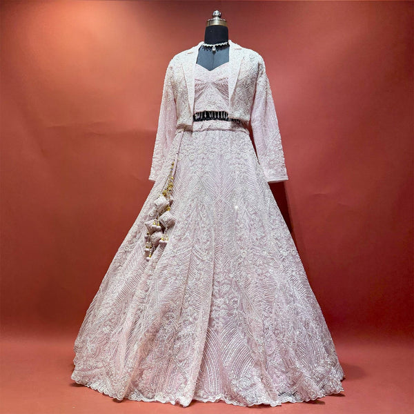 Baby pink net handwork lehenga set with jacket on mannequin