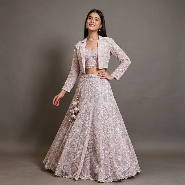 Baby pink net lehenga with beaded cropped jacket, sweetheart blouse and latkans, worn