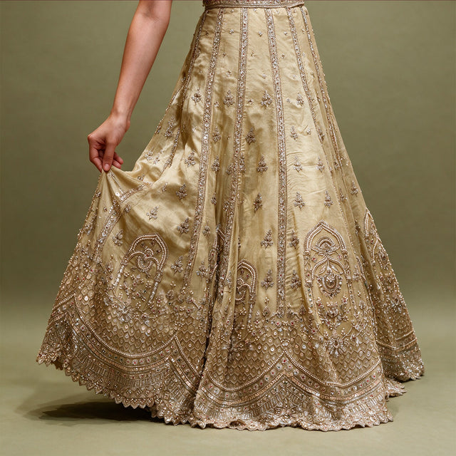 Gold crepe silk lehenga skirt with pearl and bead panel lines, arched hem motifs and scalloped edge