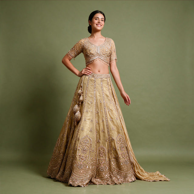 Gold viscose crepe silk handwork lehenga with beaded-fringe blouse and latkans, worn
