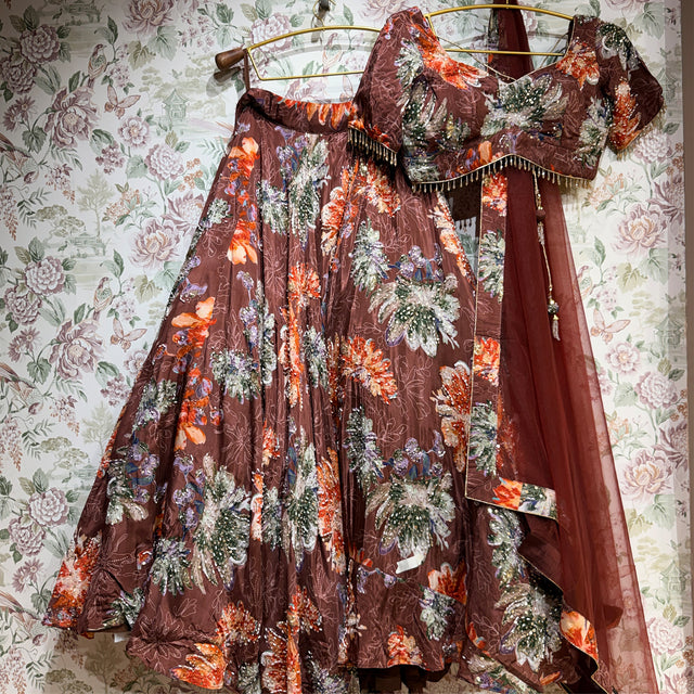Mocha floral print lehenga blouse and skirt on hanger with matching cape panel