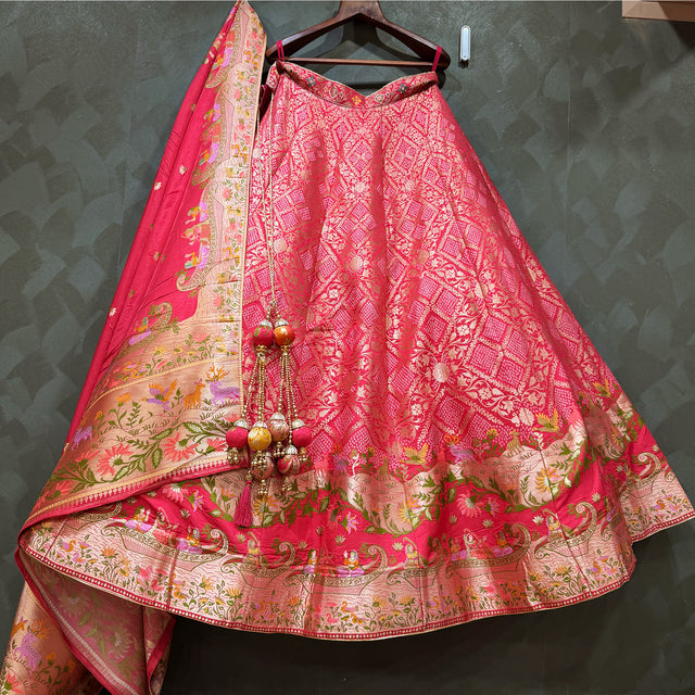 Pink Banarasi-style lehenga with multicolour woven motifs and wide gold border