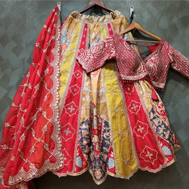 Multicolor lehenga set on hangers: red and gold embroidered skirt, blouse and dupatta